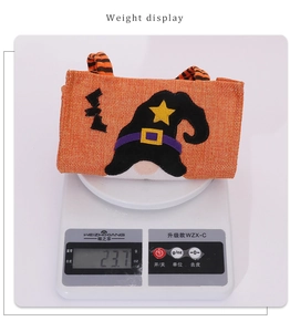 Detailed view of Halloween candy bag showing its weight at 23.7g on an electronic scale