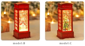 Close-up of glowing red telephone booth snow globes with snowman and Xmas tree designs