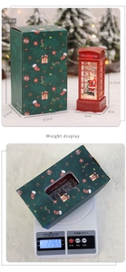 Detailed view of red Christmas phone booth snow globe with dimensions and green gift box
