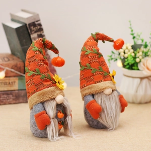 Pair of autumn harvest gnomes with orange knit hats and sunflower fall home decorations