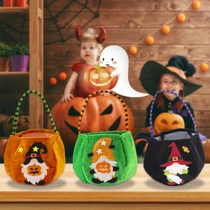 Three plush Halloween gnome gift bags with striped handles on a rustic wooden table