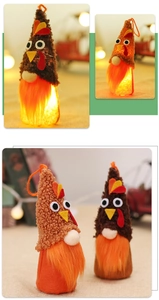 Detail of plush turkey gnomes with LED lights and warm orange beard for Thanksgiving