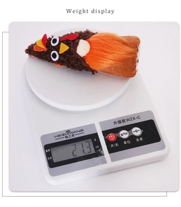 Detailed weight display of the turkey plush decoration on a white electronic scale
