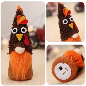 Detail view of the battery compartment and switch on the Thanksgiving turkey gnome plush
