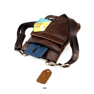Detailed side view of dark brown genuine leather messenger bag with multi-zipper pockets