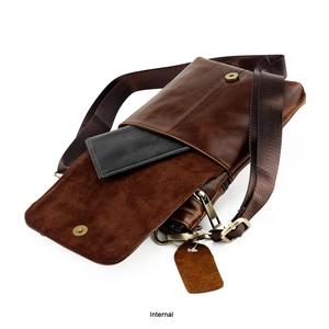 Internal view of brown leather crossbody bag showing compartments and secure zipper
