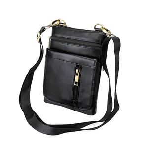 Macro view of multi-pocket genuine leather crossbody bag with vintage gold zippers