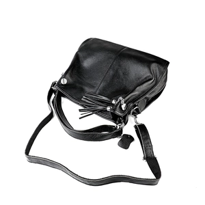 Close-up of black pebbled leather handbag with leather fringe tassel and silver hardware