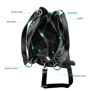 Detail of the multi-compartment interior with zip and phone pockets in black leather bag