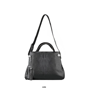 Side view of black lychee leather handbag with silver hardware and tassel charm