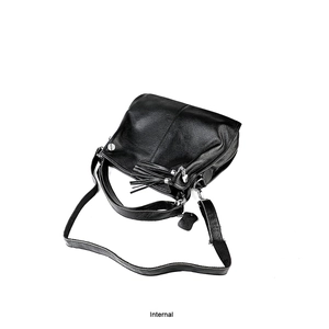 Detail of black pebbled leather handbag featuring silver hardware and tassel charm