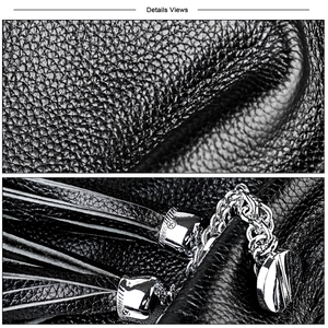 Detail view of black lychee leather bag with silver chain, logo pendant and leather tassel