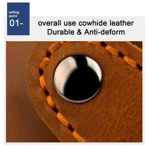 Detail of durable brown cowhide leather card holder with orange stitching and metal rivets