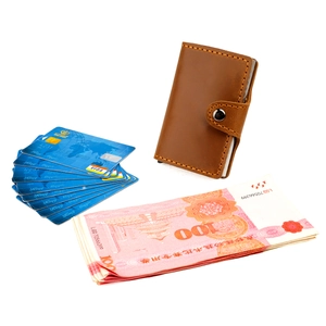 Detail view of brown vintage leather card holder with multiple slots and metal snap closure