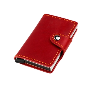 Macro detail of red crazy horse leather card holder with yellow hand-stitched seams