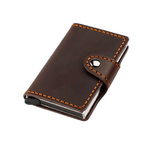 Macro shot of crazy horse leather wallet with orange contrast stitching and aluminum pop-up case