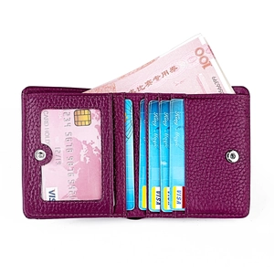 Interior detail of purple pebbled leather wallet with multiple card slots and snap closure