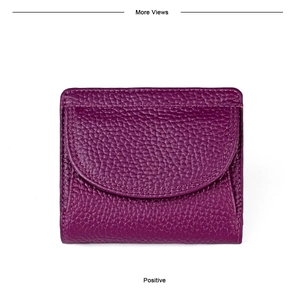 Detailed view of dark purple pebbled leather mini wallet with precise stitching