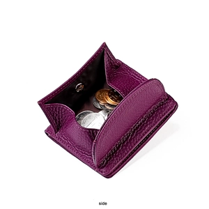 Macro view of purple litchi grain leather coin purse with metal snap button closure
