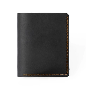 Close-up of handmade vintage crazy horse leather wallet with orange contrast stitching