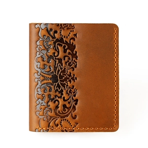 Detailed macro view of embossed vintage brown leather wallet with floral patterns