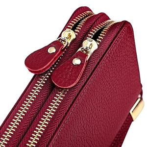 Detail shot of RFID leather wallet with pebble grain texture and dual gold zippers