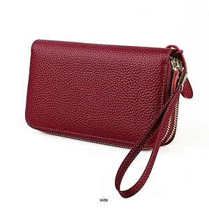 Side view of wine red lychee leather wallet with triple zipper and wrist strap