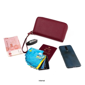 Macro view of burgundy pebble leather wallet interior with RFID card slots and phone pocket