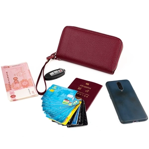 Burgundy genuine leather RFID wallet with wristlet holding phone, cards and passport