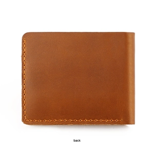 Macro detail of high-quality brown crazy horse leather and yellow stitching on wallet back