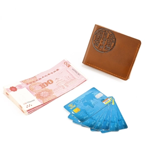 Detail of crazy horse leather wallet with traditional fish embossing and card slots