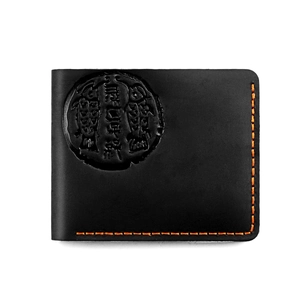 Detail of black leather wallet with orange contrast stitching and embossed fish emblem