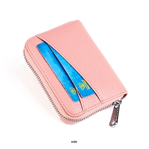 Close-up of pink litchi grain leather card holder with side slots and metal zipper