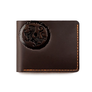 Detail of vintage brown leather wallet featuring dragon relief and orange contrast stitching
