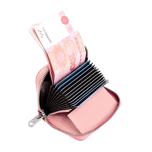 Detailed macro view of pink litchi grain leather card holder with accordion slots