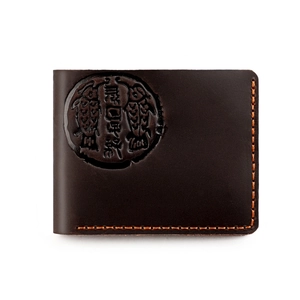 Macro view of vintage brown crazy horse leather wallet with embossed fish seal and hand-stitched detail