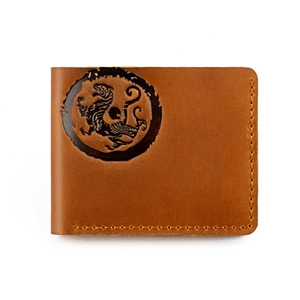 Macro view of vintage crazy horse leather wallet with embossed beast pattern and stitching