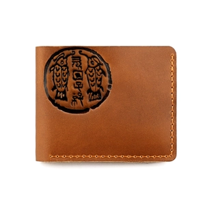 Detail of vintage crazy horse leather wallet featuring a circular embossed fish pattern