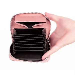 Detail of light pink pebble leather card holder with accordion slots and silver zipper