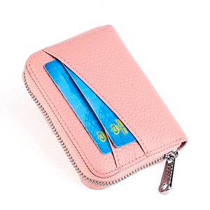 Detail of pink lychee leather card holder featuring wrap-around zipper and external slots