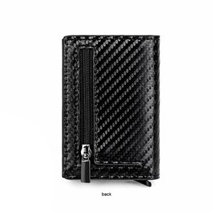 Close-up of black carbon fiber wallet back featuring a secure silver metal zipper pocket