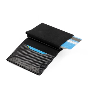 Detail of black RFID card holder showing the automatic pop-up mechanism and carbon fiber texture
