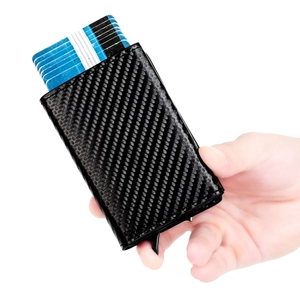 Detail of RFID blocking minimalist wallet with carbon fiber texture and card ejection mechanism