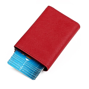 Detailed macro view of red Saffiano leather card holder with automatic pop-up mechanism