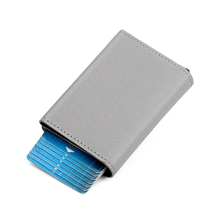 Detail view of the automatic pop-up aluminum card holder mechanism in grey leather wallet