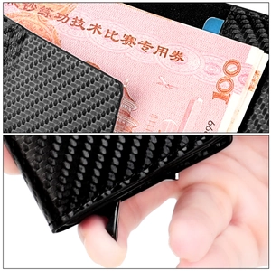 Carbon fiber wallet detail showing automatic pop-up card mechanism and banknote holder