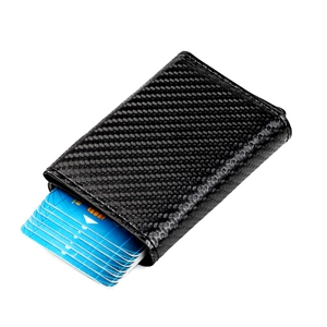 Slim carbon fiber RFID blocking wallet with pop-up card mechanism and textured finish