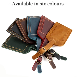 Detail view of crazy horse leather luggage tags in six vintage colors with metal buckles