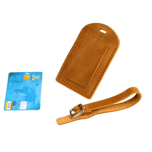 Detailed view of brown crazy horse leather luggage tag with hand-stitched edges