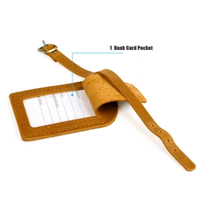 Close-up of brown vintage leather luggage tag with adjustable metal buckle and ID card